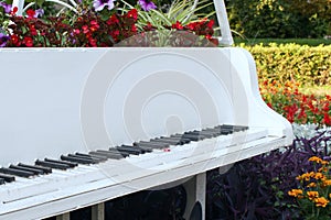 White metal grand piano on open air