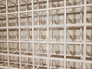 White metal lattice of squares with shadows