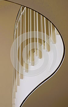 White metal pickets and brass railing on curving balcony photo