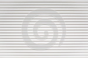 White metal roller shutter door background. Steel stripe horizontal lines of iron foldable metal sheet texture. Empty front