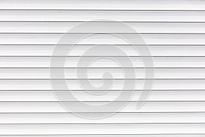 White metal roller shutter door texture background. Texture of white metal roller shutter door