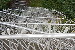 A white metal staircase zigzags up the mountain