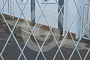 White metal texture of iron bars in the pattern in the wall of the fence