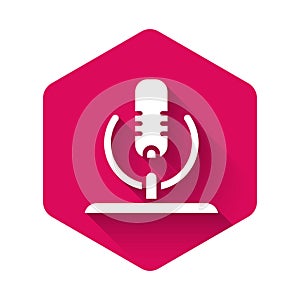 White Microphone icon isolated with long shadow. On air radio mic microphone. Speaker sign. Pink hexagon button. Vector