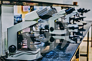 White microscope on top of black table