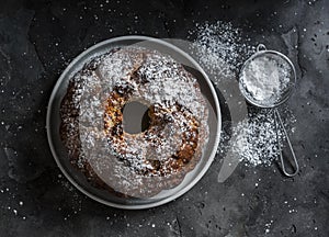 White and milk chocolate banana oatmeal cake on a dark table background, top view. Delicious breakfast, snack, dessert