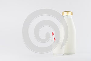 White milk, dairy product in glass bottle  mock up with glass, red straped straw in soft light white background.