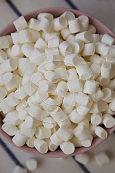 White Mini Marshmallows in a Pink Bowl, top view. Flat lay, overhead, from above