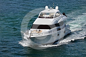 White Mini-Motor Yacht Cruising off Miami Beach