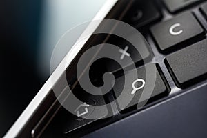 A White Mobile With Blue Reflection On A Keyboard With Search Button #1