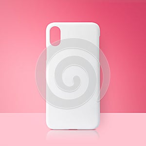 White mobile cover on pink backdrops. Blank phone case for printing