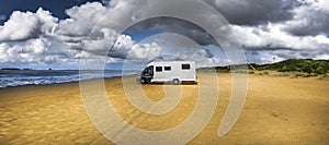 Mobile home parked on the beach photo