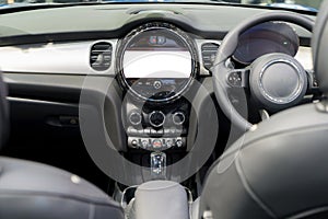 White mockup of digital display screen on the dashboard of a modern car