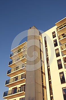 White modern apartments building facade in sunlight on a sunny day with clear blue sky. Vana - Kuuli street.
