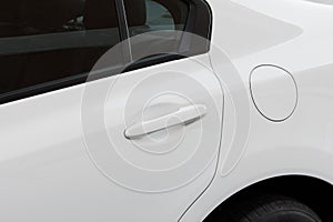 White modern car details - fuel tank cap ( closed petrol cover ) and door handle