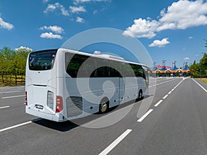 White Modern comfortable tourist bus driving through highway to Disneyland.