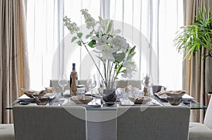 White modern dinning room with flower on table