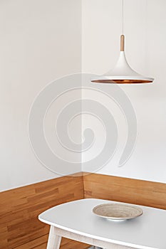 White modern electric lamp over kitchen table