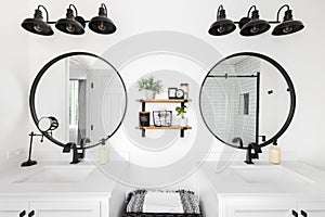 A white modern farmhouse bathroom with black accents.