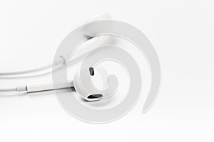 White modern headphones with a headset on a light gray background