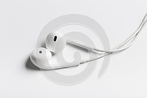 White modern headphones with a headset on a light gray background