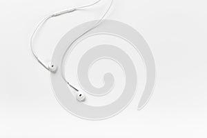 White modern headphones with a headset on a light gray background