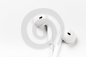 White modern headphones with a headset on a light gray background