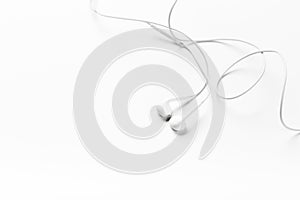 White modern headphones with a headset on a light gray background