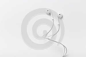 White modern headphones with a headset on a light gray background