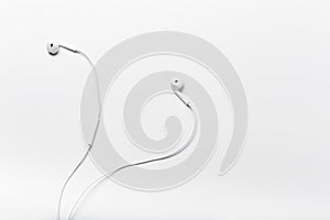 White modern headphones with a headset on a light gray background