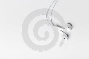 White modern headphones with a headset on a light gray background