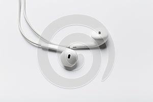 White modern headphones with a headset on a light gray background