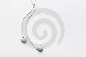 White modern headphones with a headset on a light gray background