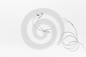 White modern headphones with a headset on a light gray background