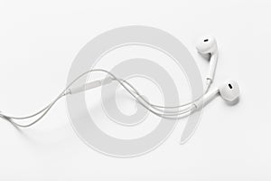 White modern headphones with a headset on a light gray background