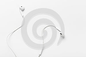 White modern headphones with a headset on a light gray background