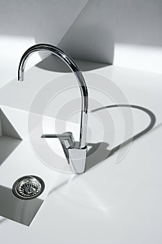 White modern kitchen detail, faucet and sink