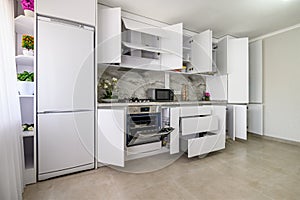 White modern kitchen interior, some drawers pulled out