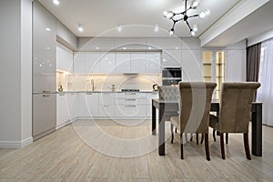 White modern new well designed white kitchen in studio flat interior