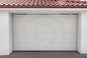 White modern sectional garage doors on building