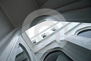 White modern arch building architecture in urbanized area photo