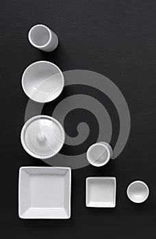 White, modern tableware in various designs on a black background