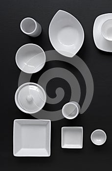 White, modern tableware in various designs on a black background