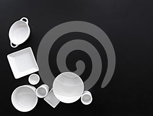 White, modern tableware in various designs on a black background