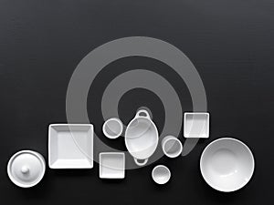 White, modern tableware in various designs on a black background