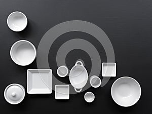 White, modern tableware in various designs on a black background
