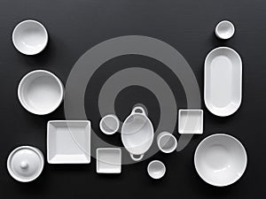 White, modern tableware in various designs on a black background