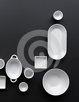White, modern tableware in various designs on a black background