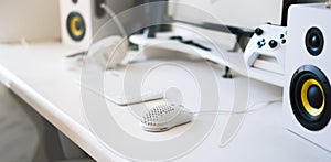 White modern wired gaming mouse in a white comfortable gamer workspace. Close-up of a special device