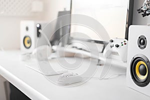 White modern wired gaming mouse in a white comfortable gamer workspace. Close-up of a special device